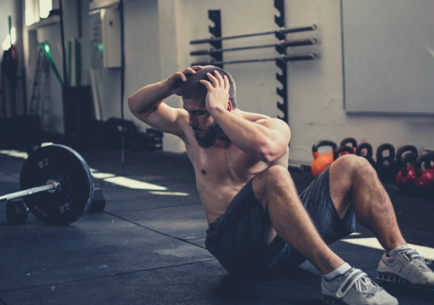 muscular man doing sit ups