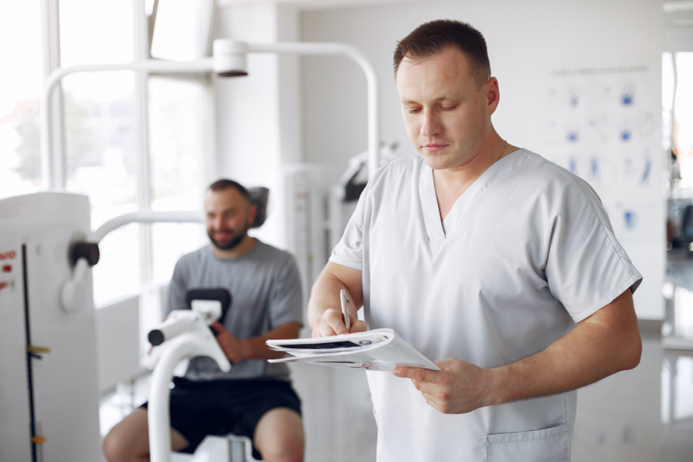 doctor with a patient in physiotherapy bodybuilding clinic