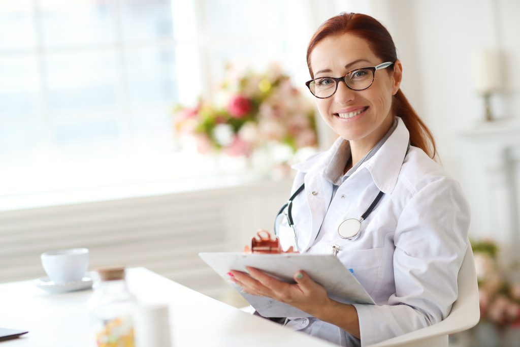 woman doctor taking notes