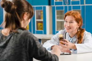 Young female doctor talking with the patient