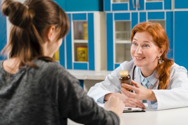 Young female doctor talking with the patient