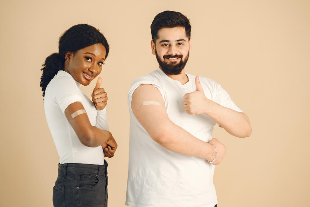 a couple who donated blood showing off their stickers