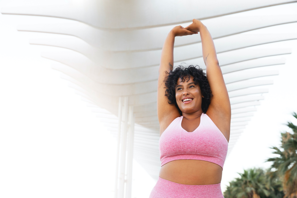 photo low angle smiley woman stretching