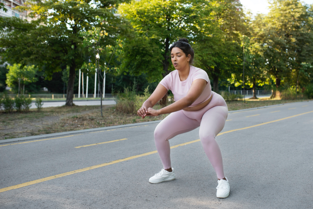 photo overweight woman exercising outdoors