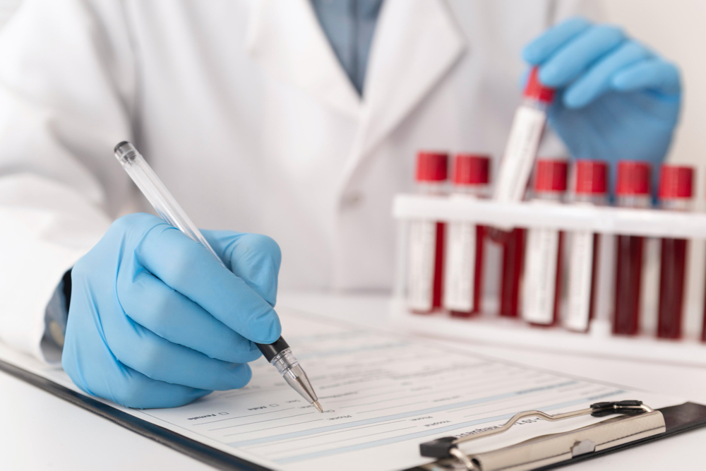 lab tech looking at blood tests in tube