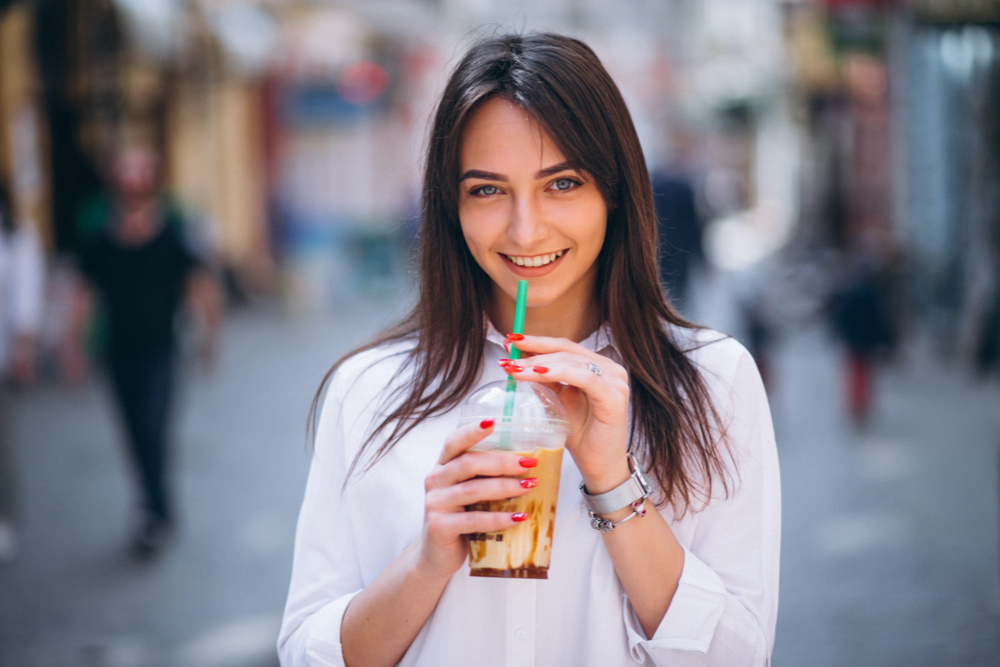 woman with sugary coffee in a street