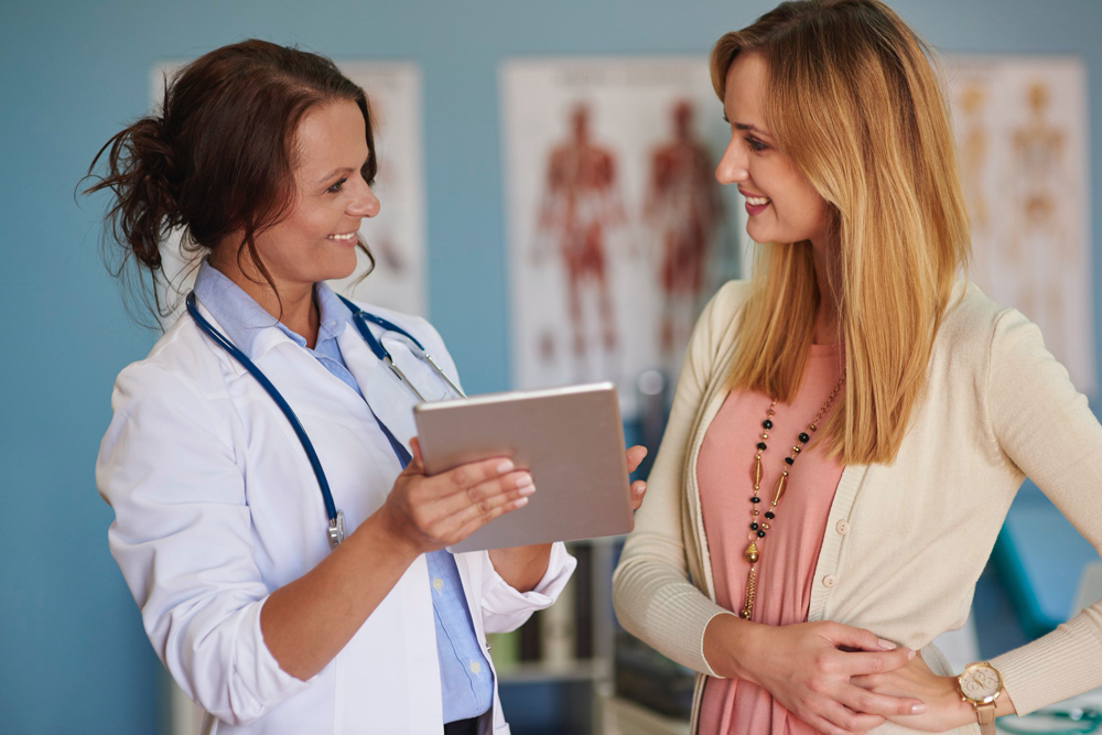 doctor speaking to young woman about lab results