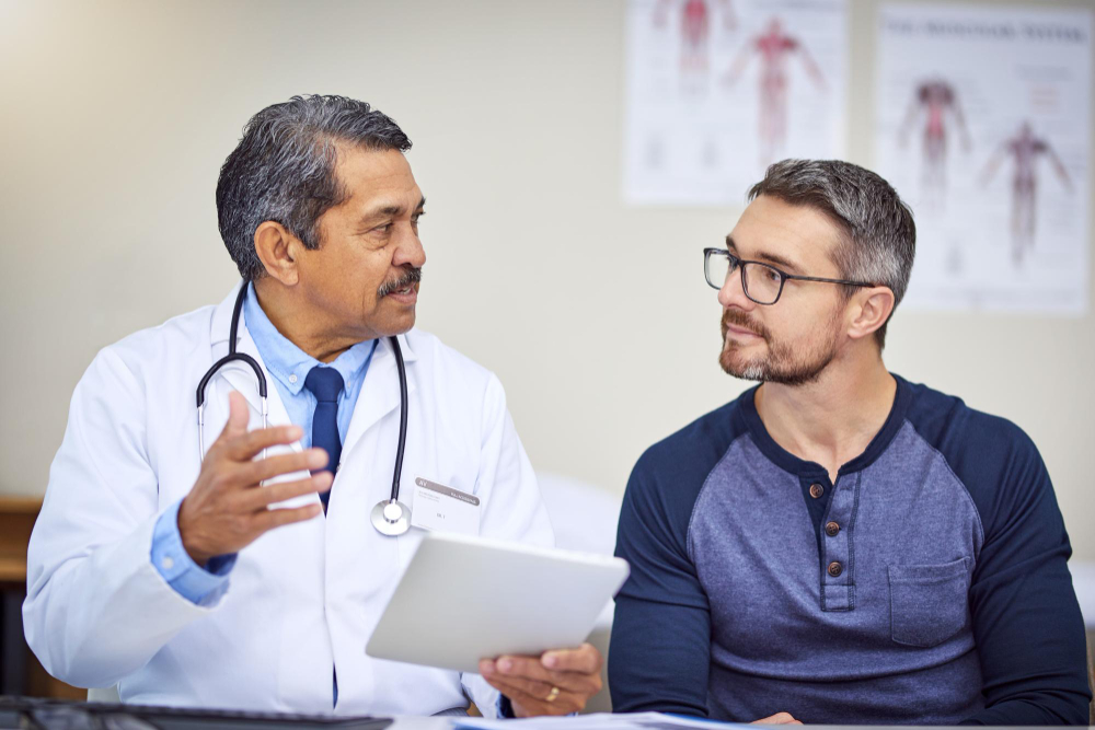 man speaking with doctor