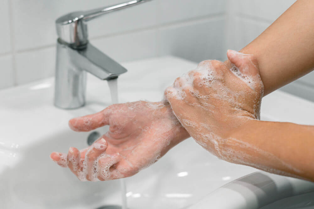 Person washing wrist with soap
