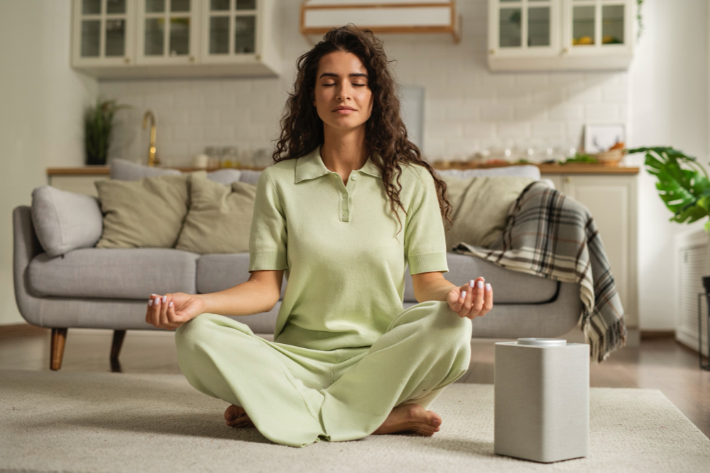 Full shot woman meditating at home