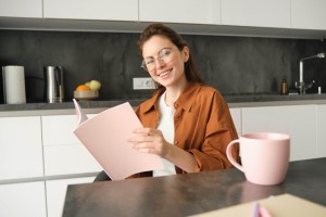 Portrait of young woman working from home selfemployed entrepreneur reading her documents sitting at